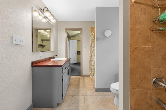 bathroom with ceiling fan, tile patterned floors, toilet, vanity, and a shower with shower curtain