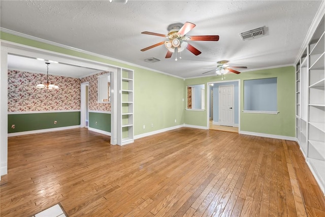 interior space with built in shelves, crown molding, and a textured ceiling