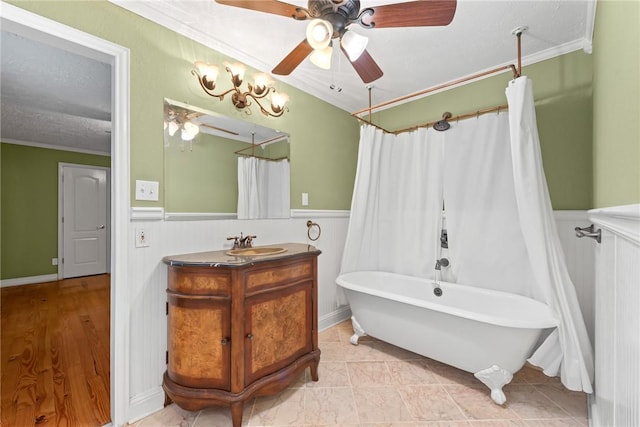 bathroom with vanity, crown molding, ceiling fan, shower / bath combo with shower curtain, and a textured ceiling