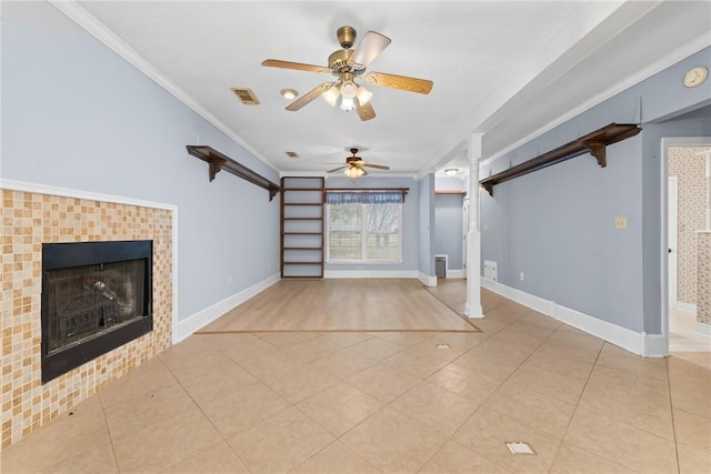 unfurnished living room with a tile fireplace, crown molding, ceiling fan, and light tile patterned floors