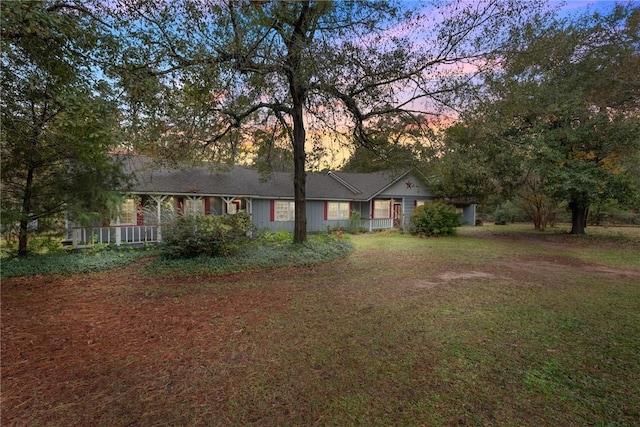 ranch-style home with a yard