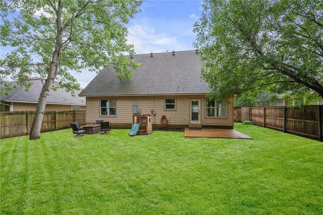 1905 Kingsgate Dr, Bryan, TX 77807 - back of house with roof with shingles and a fire pit