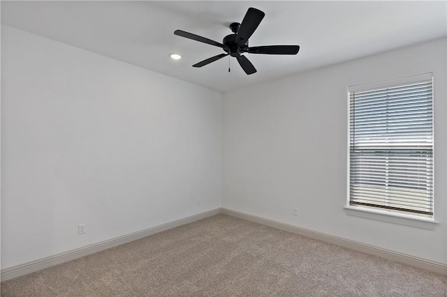 spare room featuring light carpet, baseboards, a ceiling fan, and recessed lighting