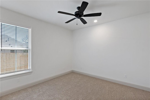 empty room featuring light colored carpet, baseboards, ceiling fan, and recessed lighting