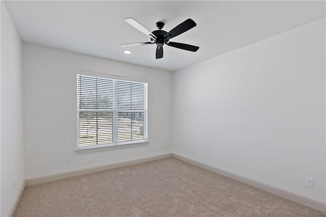 carpeted empty room featuring baseboards, a ceiling fan, and recessed lighting