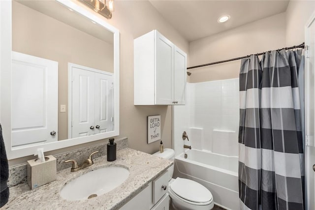 full bathroom with vanity, shower / bath combination with curtain, and toilet