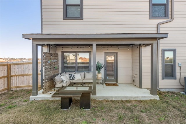 exterior space featuring an outdoor hangout area, a patio area, and a lawn