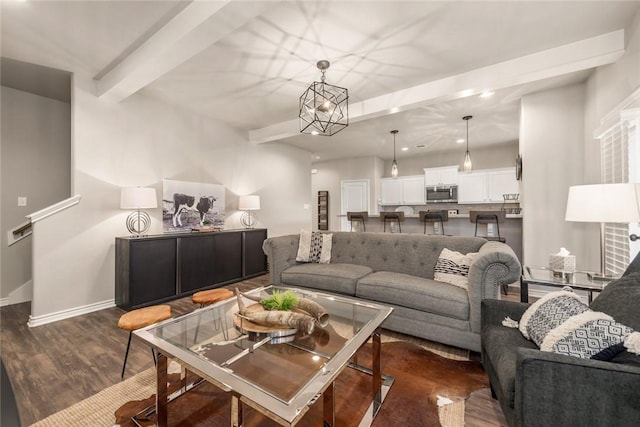 living room featuring beamed ceiling, an inviting chandelier, and dark hardwood / wood-style flooring