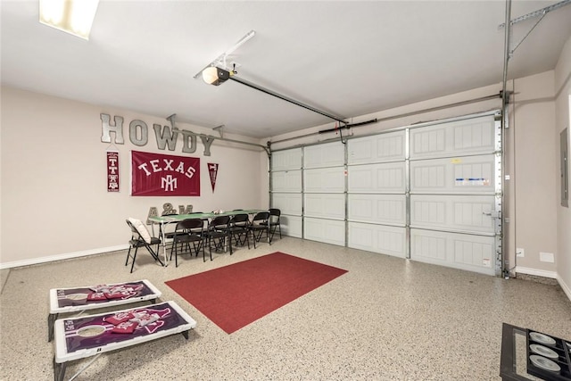 garage with a garage door opener and electric panel