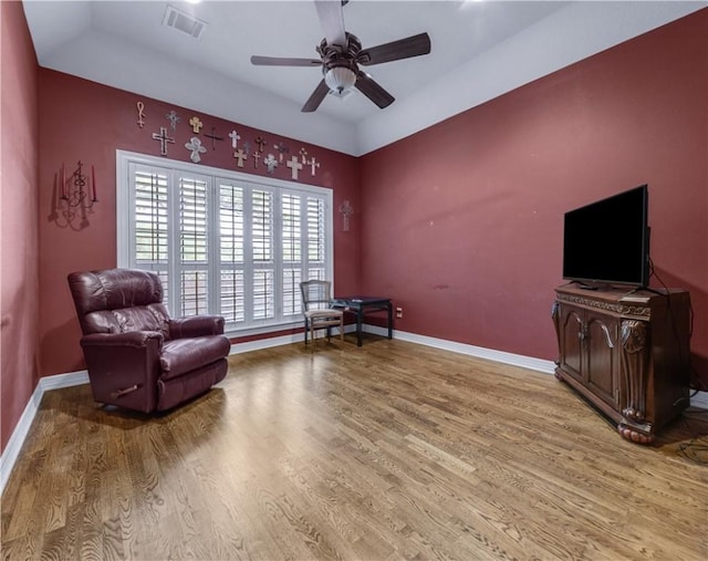 living area featuring ceiling fan and light hardwood / wood-style flooring