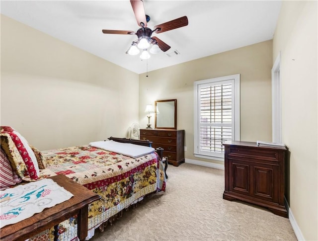 bedroom featuring ceiling fan and light carpet