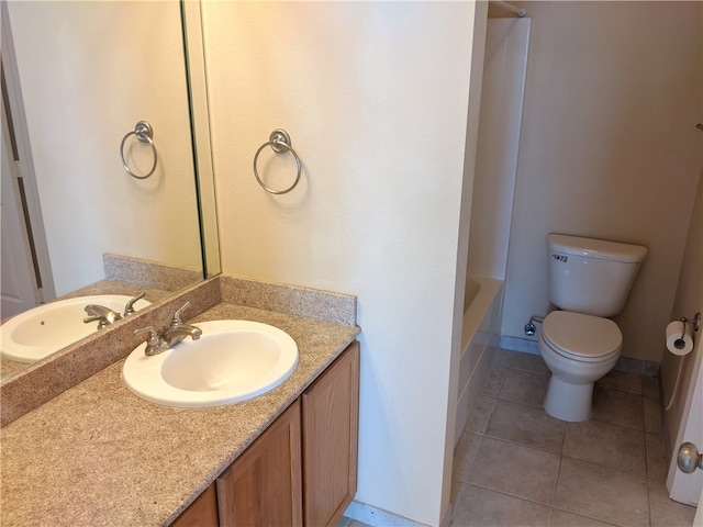 bathroom featuring toilet, vanity, and tile patterned flooring