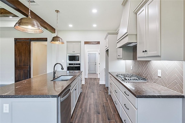2803 Spector Dr, Bryan, TX 77808 - kitchen with a sink, appliances with stainless steel finishes, dark wood-type flooring, backsplash, and custom exhaust hood