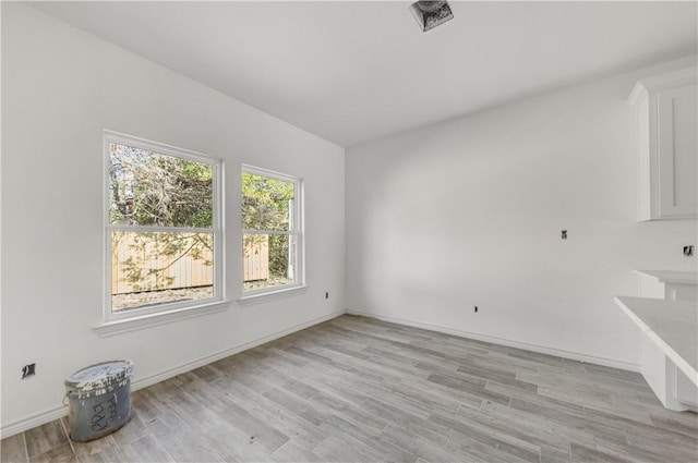 spare room with light hardwood / wood-style flooring