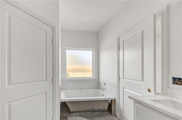 bathroom featuring a tub and vanity