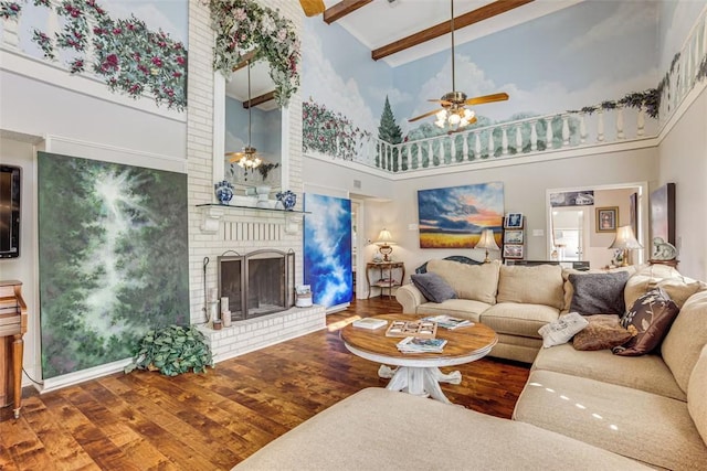 601 E Collard St, Madisonville, TX 77864 - living area featuring ceiling fan, a towering ceiling, wood finished floors, a brick fireplace, and beamed ceiling