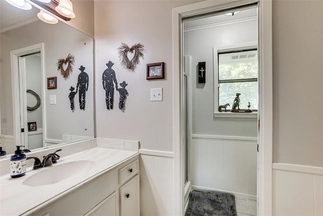 601 E Collard St, Madisonville, TX 77864 - full bath with a decorative wall, vanity, a wainscoted wall, and an enclosed shower
