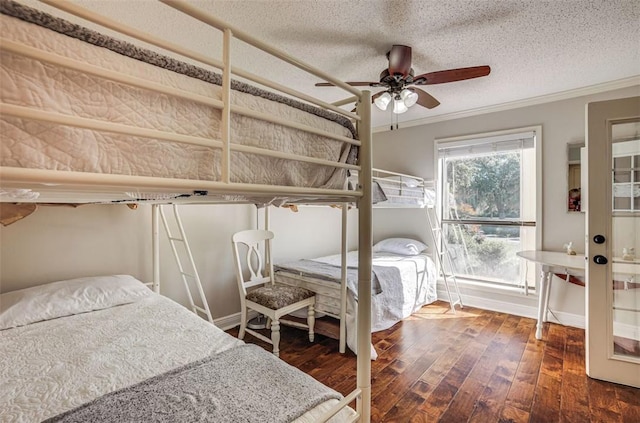 601 E Collard St, Madisonville, TX 77864 - bedroom with wood-type flooring, ornamental molding, a textured ceiling, and ceiling fan