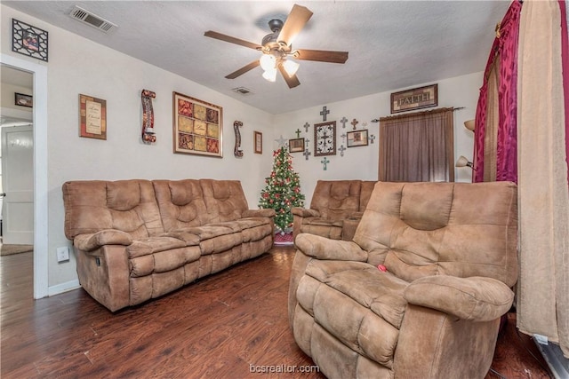 living room featuring a textured ceiling, ceiling fan, and dark hardwood / wood-style floors