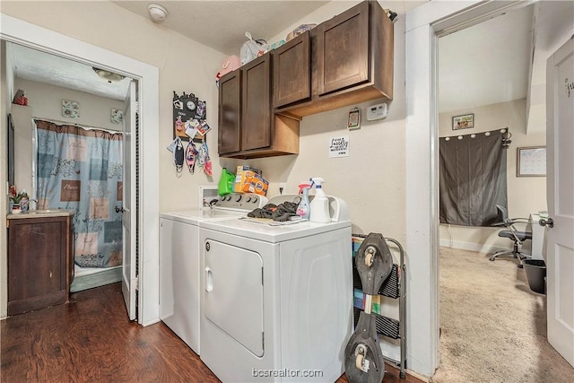 clothes washing area with cabinets, dark hardwood / wood-style flooring, washer and clothes dryer, and sink