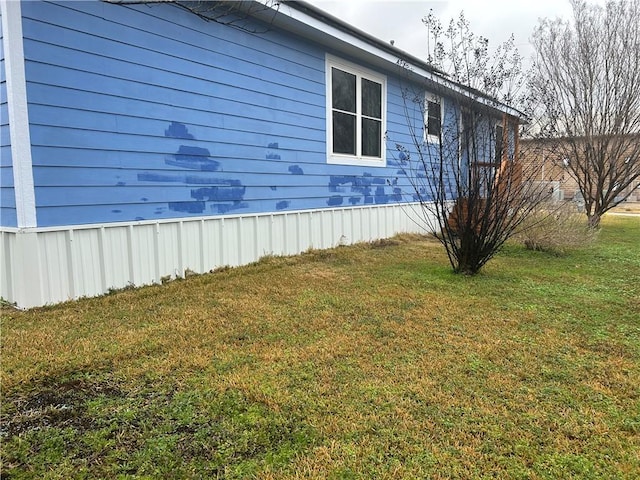 view of property exterior featuring a lawn