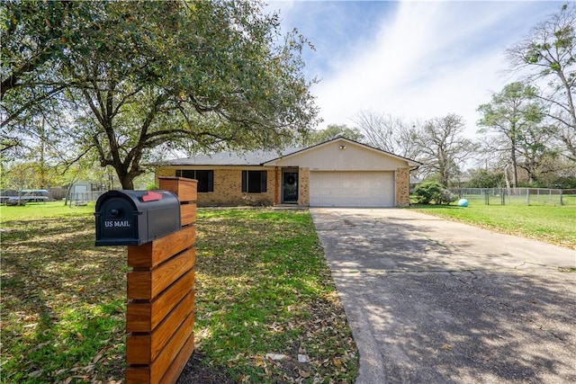 view of front of property featuring brick siding, fence, a front yard, driveway, and an attached garage