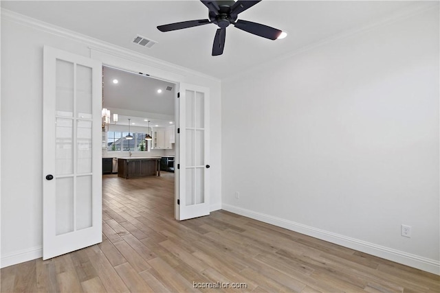 spare room with french doors, light hardwood / wood-style flooring, ceiling fan, and ornamental molding