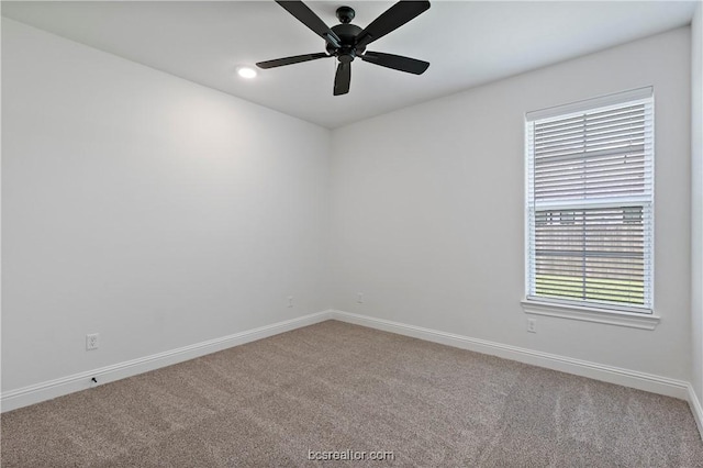 carpeted empty room featuring ceiling fan