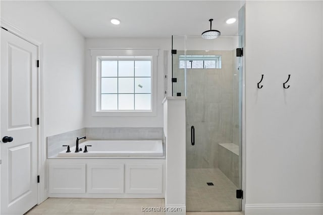 bathroom featuring tile patterned flooring and independent shower and bath