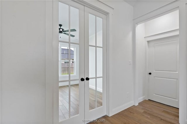 doorway featuring ceiling fan, light hardwood / wood-style flooring, and french doors