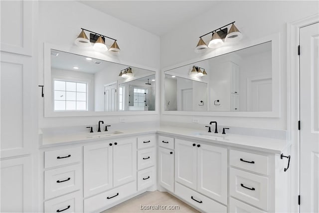 bathroom with tile patterned flooring and vanity