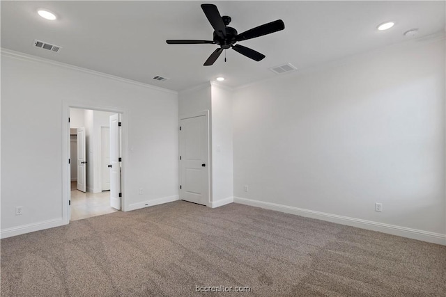 empty room with light colored carpet, ceiling fan, and crown molding