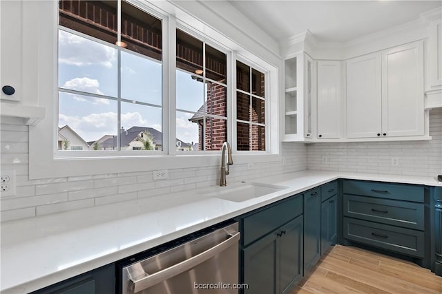 kitchen featuring white cabinets, dishwasher, sink, and a wealth of natural light