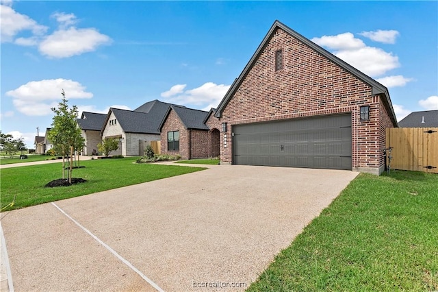 view of front of property with a garage and a front lawn