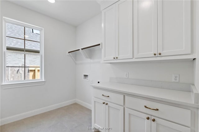 laundry area featuring cabinets, washer hookup, and electric dryer hookup