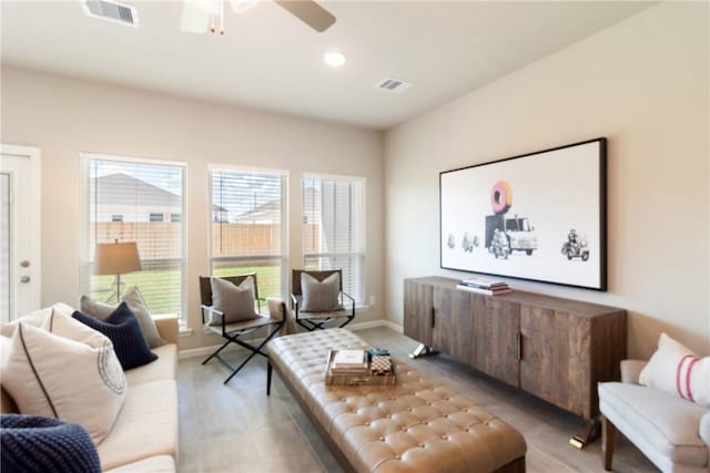 living area with a ceiling fan, recessed lighting, visible vents, and baseboards