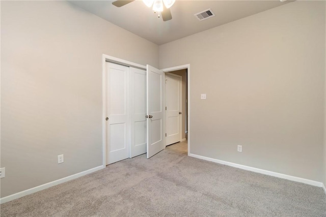 unfurnished bedroom with a closet, baseboards, visible vents, and carpet flooring