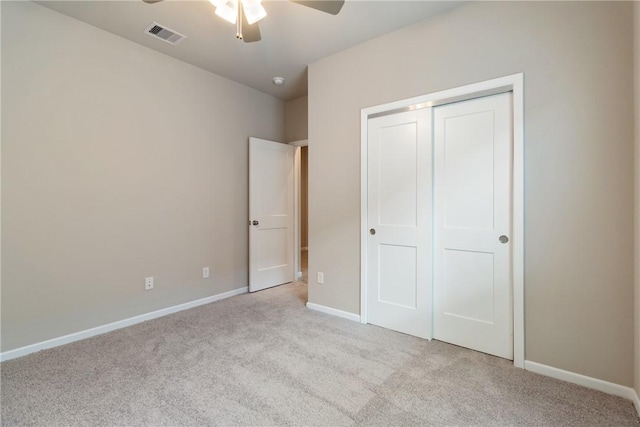 unfurnished bedroom with a ceiling fan, visible vents, baseboards, a closet, and carpet