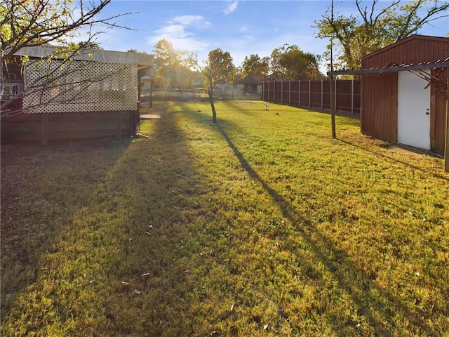 view of yard with a shed and a deck