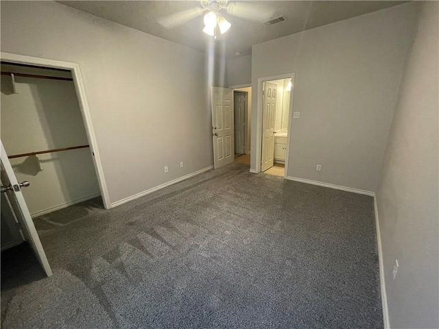 unfurnished bedroom featuring visible vents, carpet floors, baseboards, ceiling fan, and ensuite bathroom