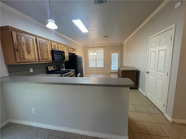 kitchen featuring light tile patterned floors, crown molding, baseboards, black appliances, and hanging light fixtures