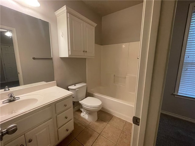 bathroom featuring vanity, toilet, tile patterned flooring, and bathing tub / shower combination