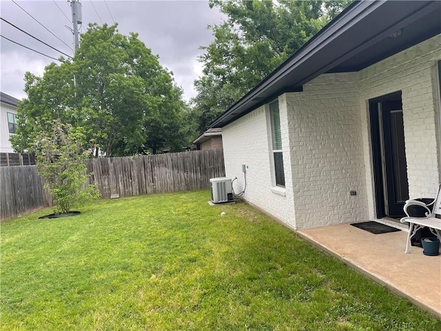 view of yard featuring cooling unit and fence