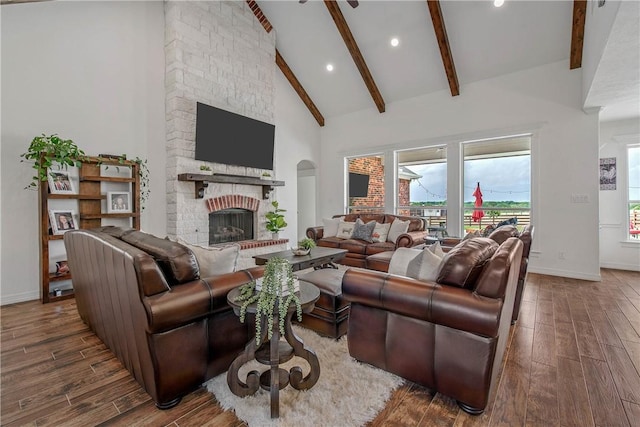 2181 Fm 166, Caldwell, TX 77836 - living room featuring wood finished floors, baseboards, a brick fireplace, beamed ceiling, and high vaulted ceiling