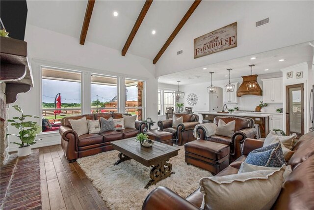 2181 Fm 166, Caldwell, TX 77836 - living area featuring high vaulted ceiling, dark wood finished floors, beamed ceiling, and recessed lighting