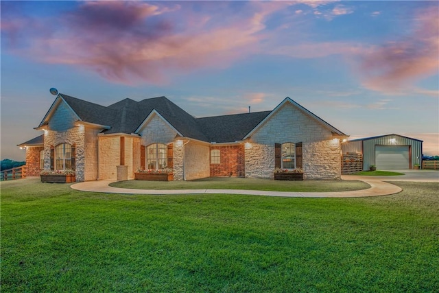 2181 Fm 166, Caldwell, TX 77836 - view of front of property featuring stone siding, an outbuilding, a garage, and a yard