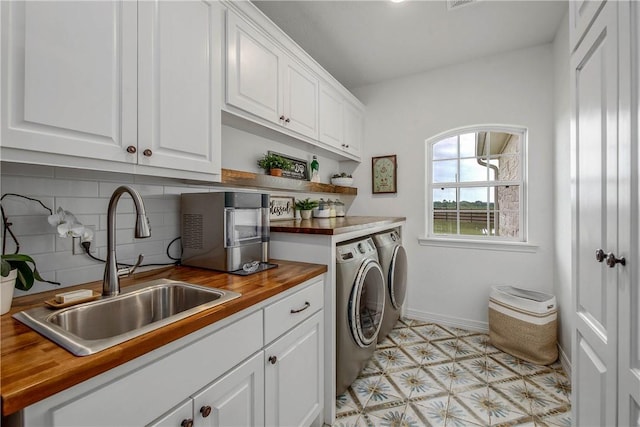2181 Fm 166, Caldwell, TX 77836 - laundry area with washing machine and dryer, cabinet space, and baseboards