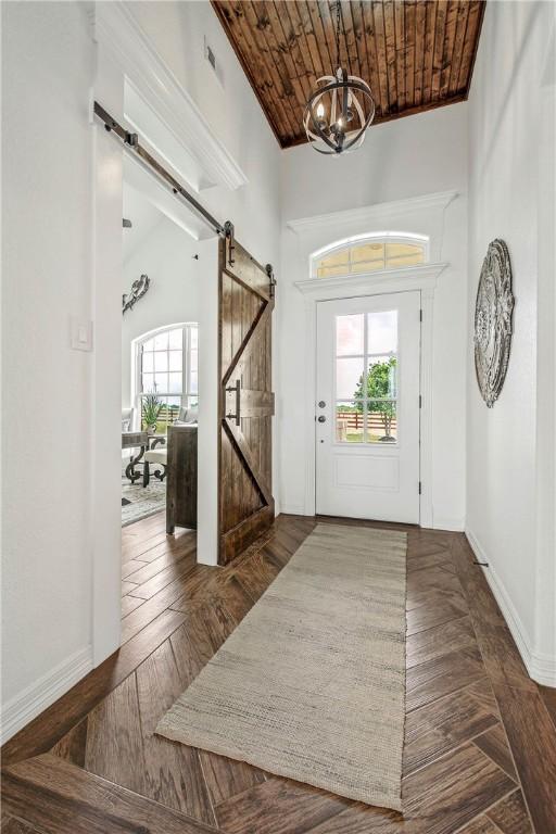 2181 Fm 166, Caldwell, TX 77836 - foyer entrance with a barn door, a chandelier, baseboards, and wood ceiling