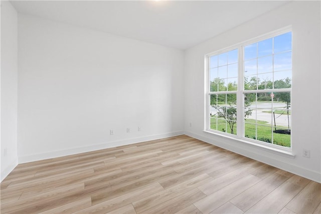 empty room with plenty of natural light and light wood-type flooring