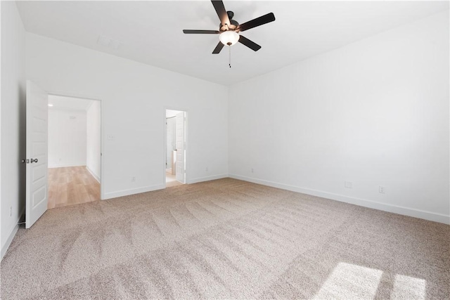 unfurnished room featuring light colored carpet and ceiling fan